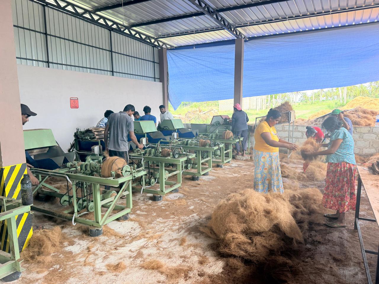Factory workers processing coir